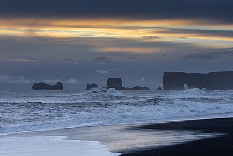 Reynisfjara black sand beach and  Dyrhlaey promontory in the storm, Myrdalur, Iceland